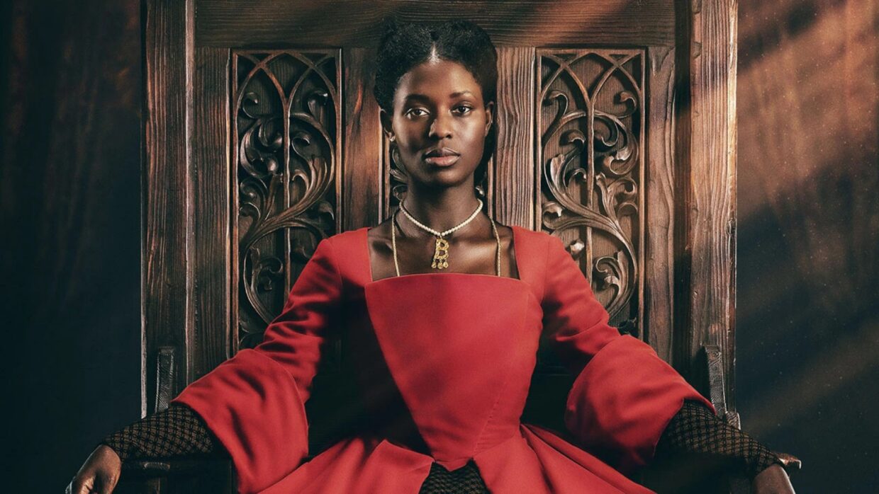 Jodie Turner-Smith in a red dress on a throne, in Anne Boleyn on Showmax